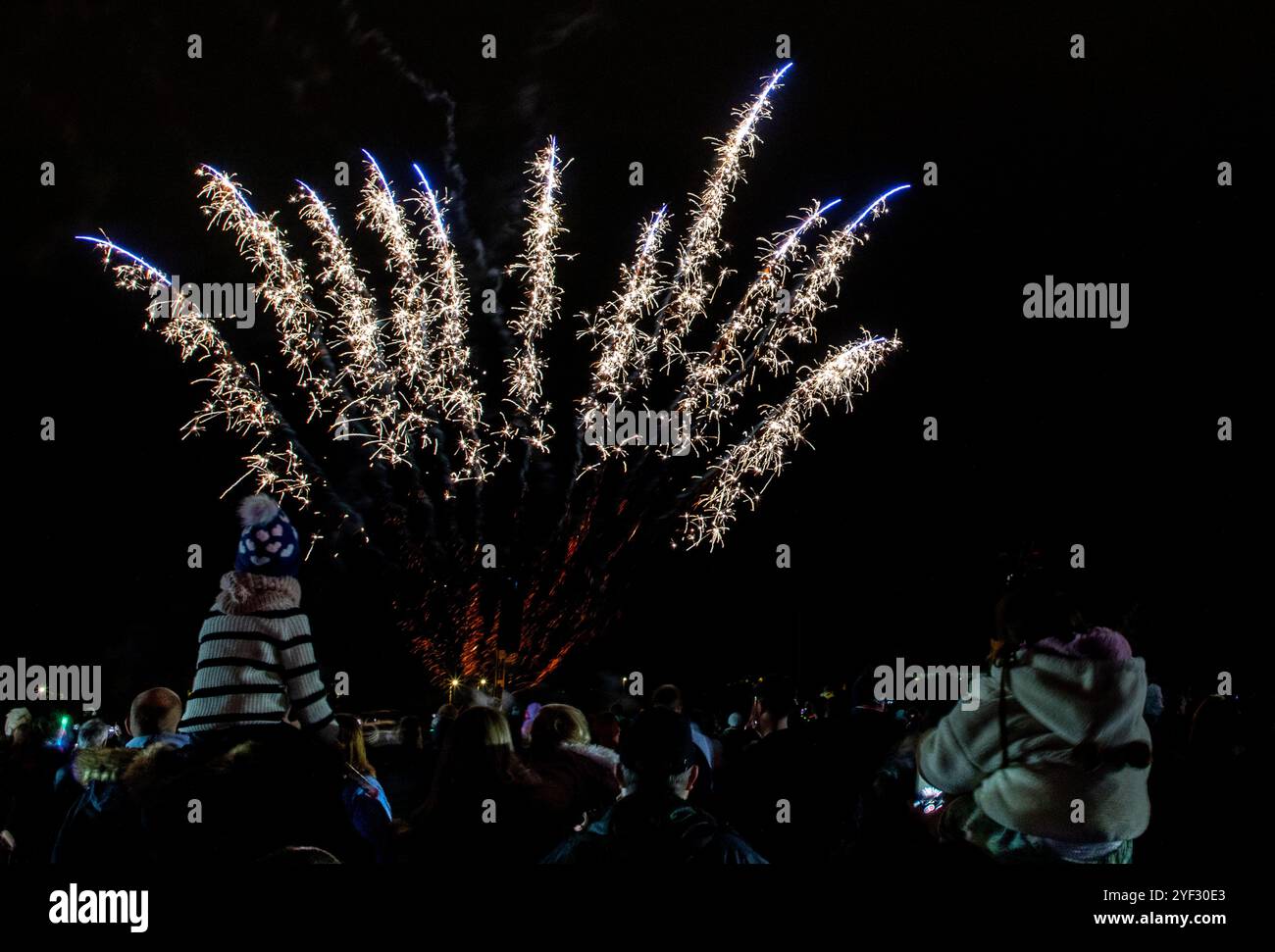 Crowds watching the Bicester Round Table 2024 annual fireworks display in Pingle Field, Bicester, Oxfordshire. Stock Photo