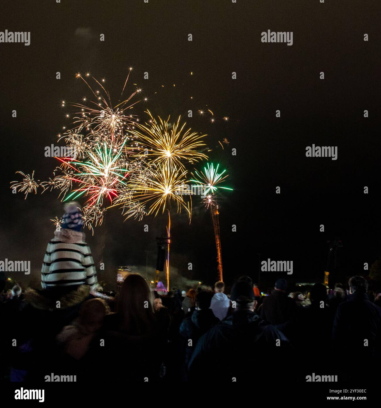 Crowds watching the Bicester Round Table 2024 annual fireworks display in Pingle Field, Bicester, Oxfordshire. Stock Photo