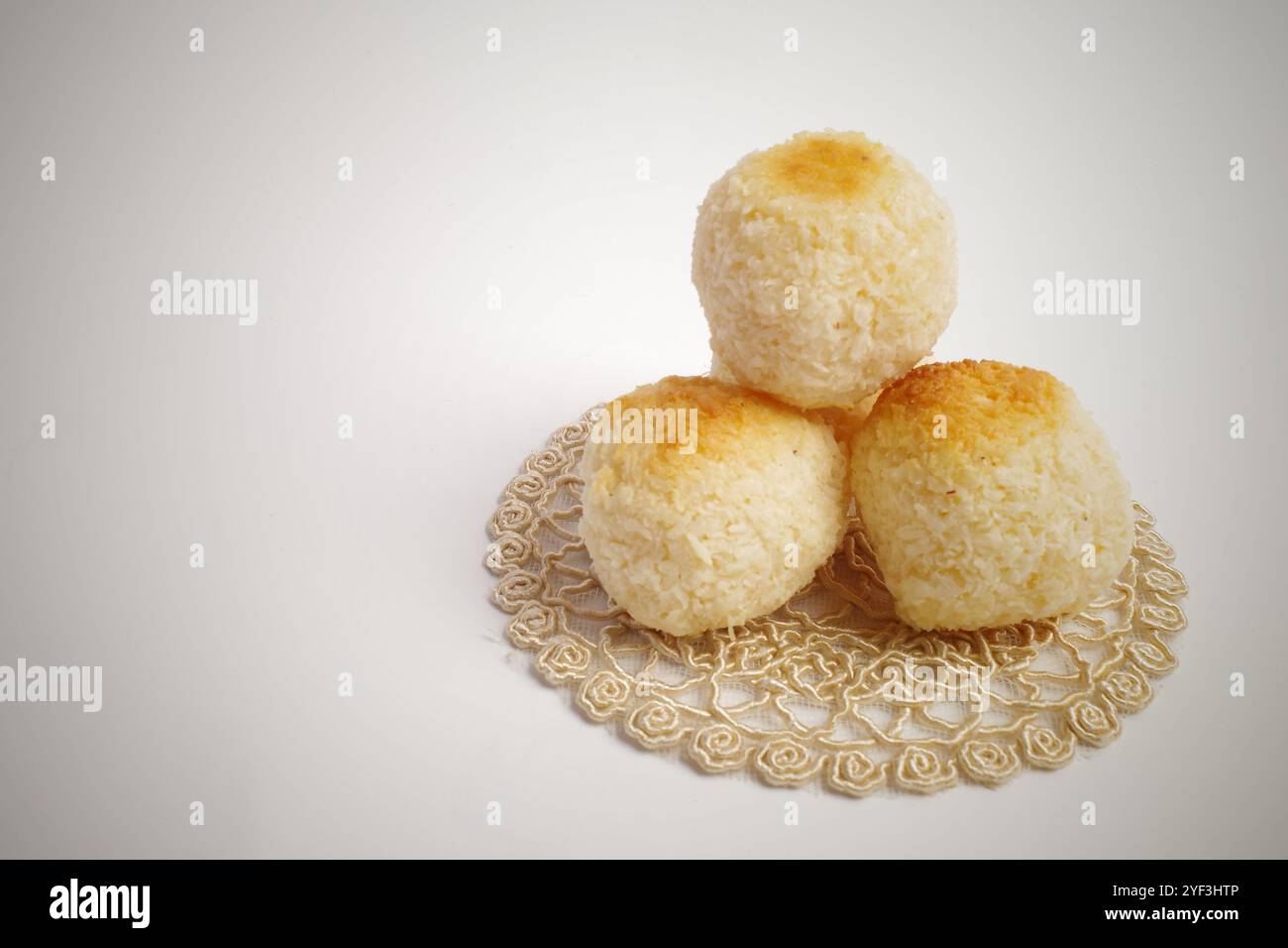 Three Toasted Coconut Macaroons on a Doily Stock Photo