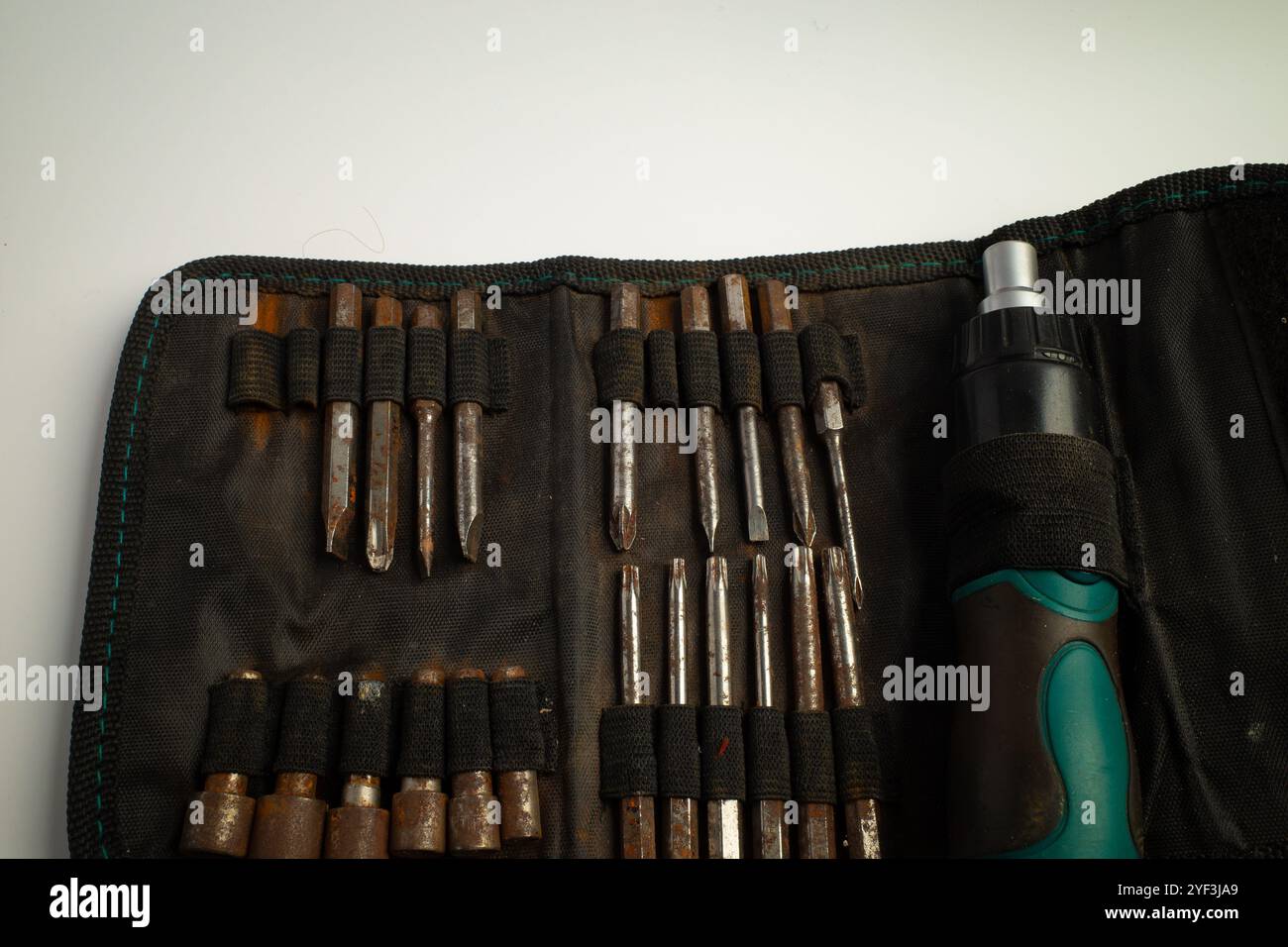 Tool set with multiple screwdrivers and bits in a fabric pouch Stock Photo