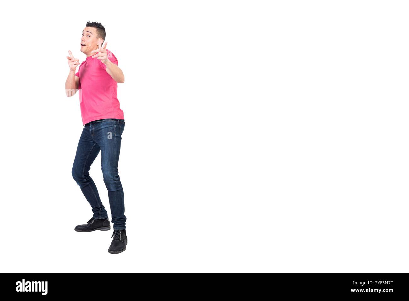 Cheerful young man pointing at camera in white studio Stock Photo