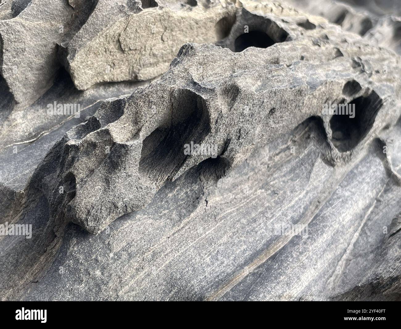 closeup view of a schist, metamorphic rock, on a beach, Cadaques, Catalonia, Spain - Smartphone Captured Stock Image
