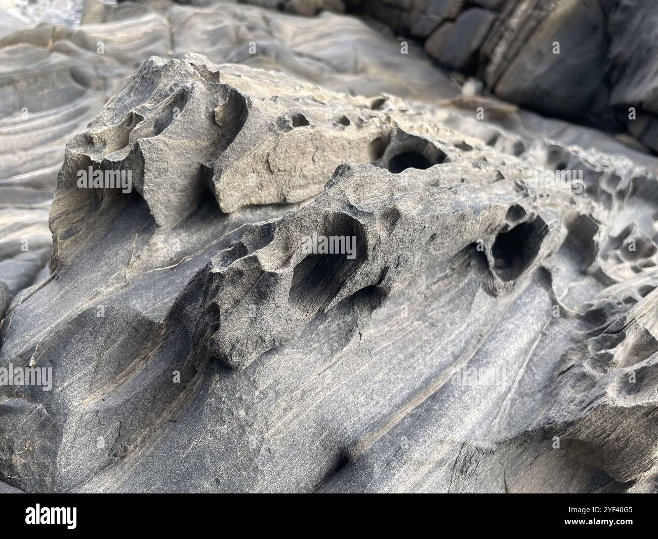 closeup view of a schist, metamorphic rock, on a beach, Cadaques, Catalonia, Spain - Smartphone Captured Stock Image