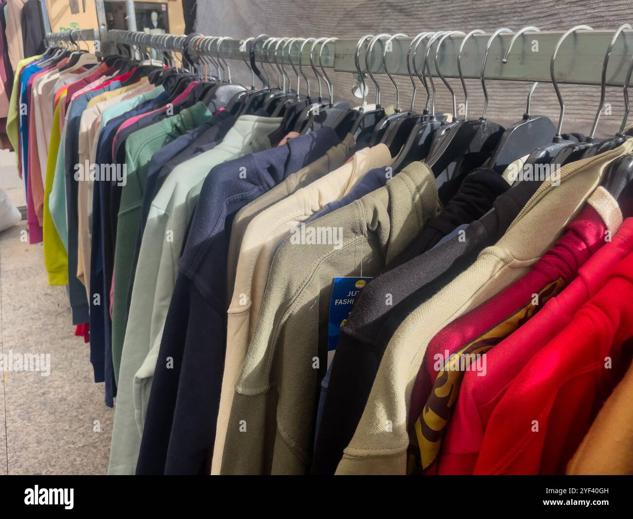 load of  jersey on a street market stall, Vic, Catalonia, Spain - Smartphone Captured Stock Image