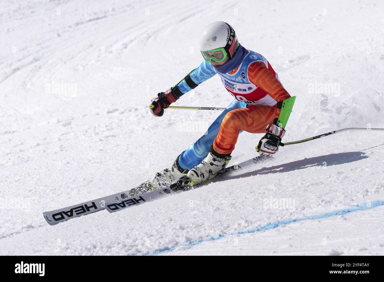 MOROZNAYA MOUNT, KAMCHATKA PENINSULA, RUSSIAN FEDERATION, APR 1, 2019: Mountain skier Victoria Fugleva Sakhalin Region skiing down mountain slope. Rus Stock Photo