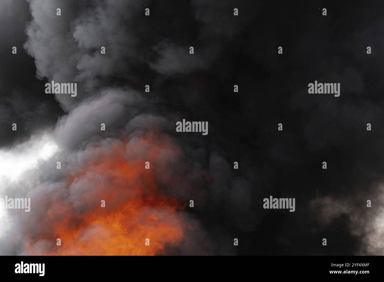Dangerous flames of strong red fire and motion clouds of black smoke ...