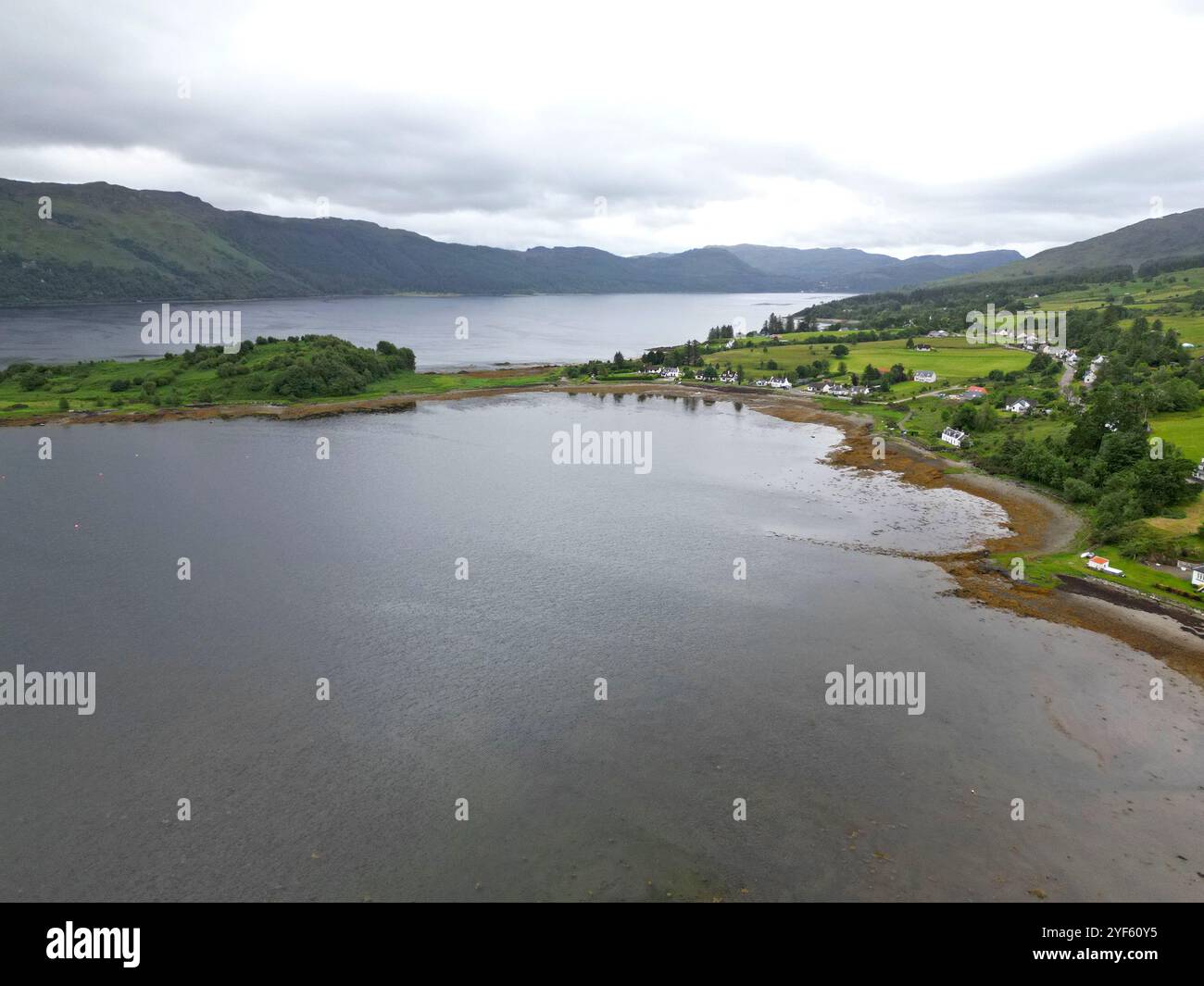 Aerial drone view of the Scottish Highland village of Lochcarron, alongside the loch, Wester Ross, Scotland, June 2024 Stock Photo