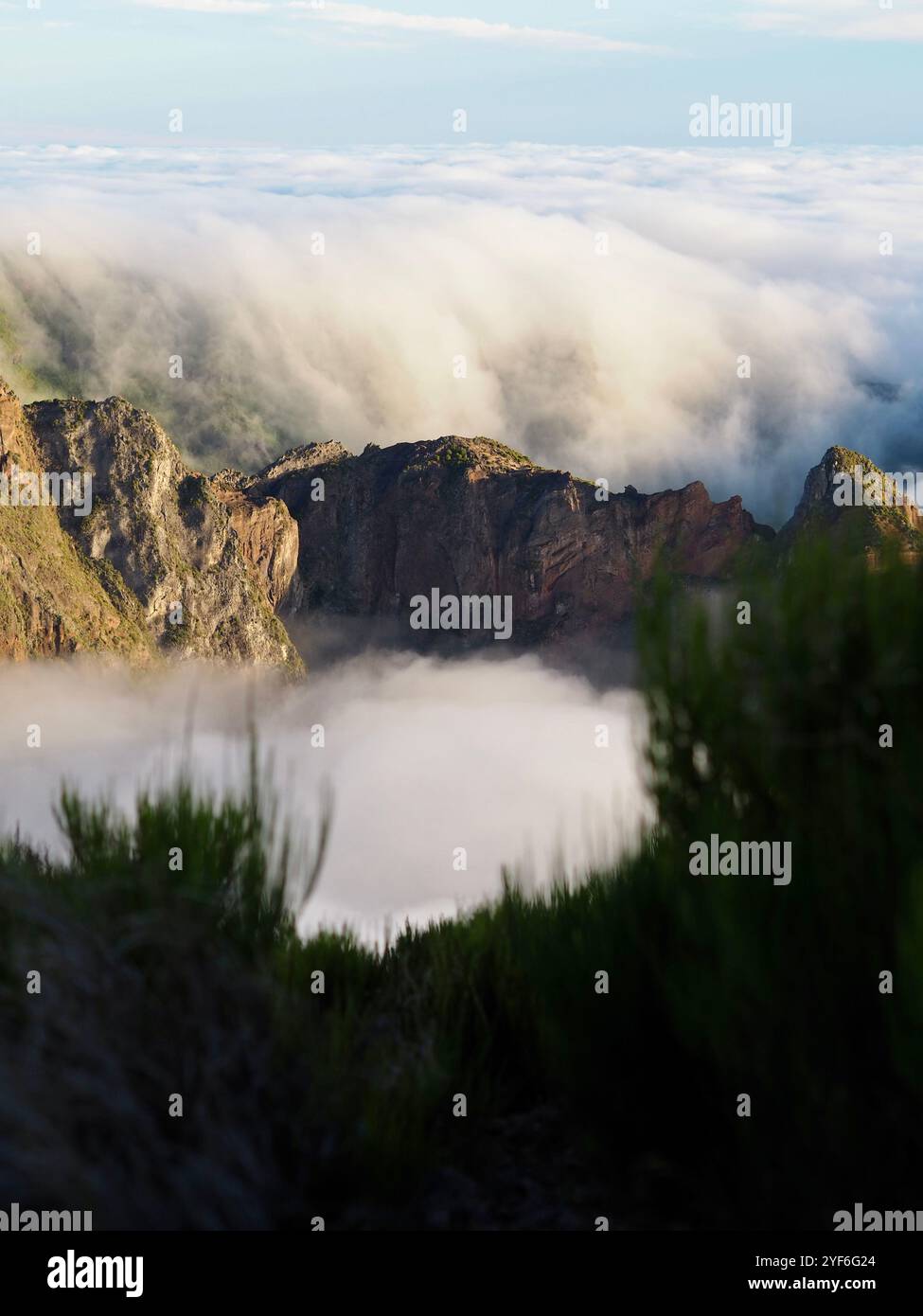 Ridge Example Nature Mountain ridges enveloped in clouds bask in the golden hues of morning ...