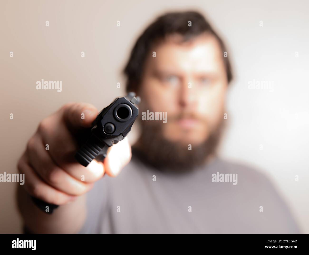 Man Aiming Gun Directly at the Camera for Dramatic Effect Stock Photo ...