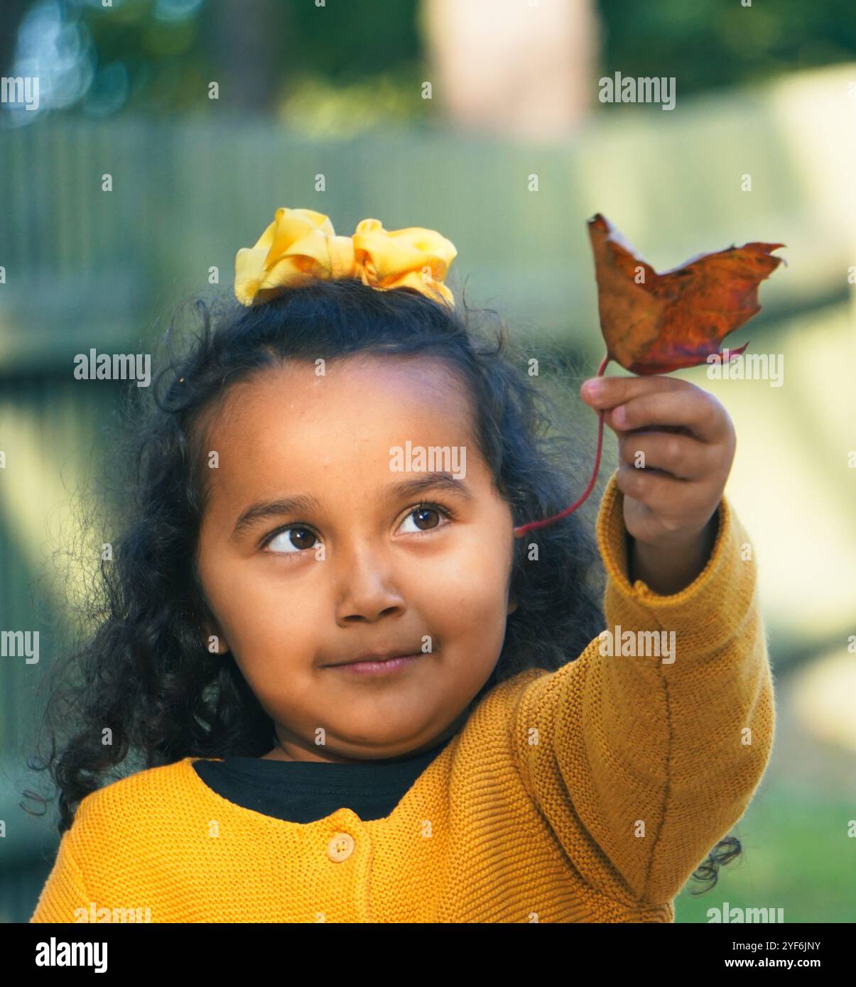 Girl holding a leaf hi-res stock photography and images - Alamy