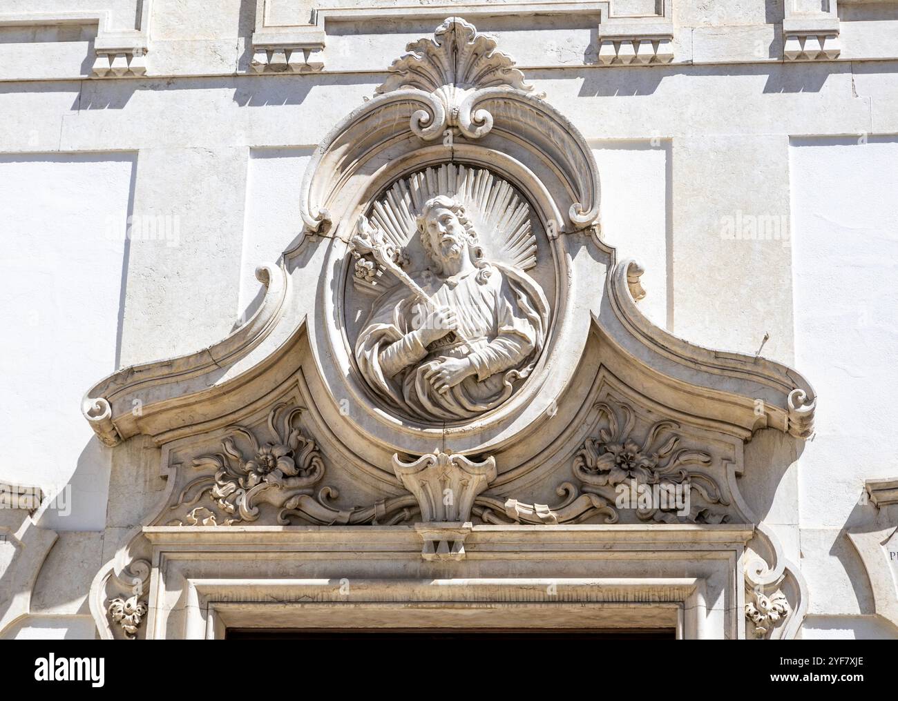 Medallion of Saint Joseph of the Carpenters above the portal of the church of the same name in Lisbon, Portugal Stock Photo