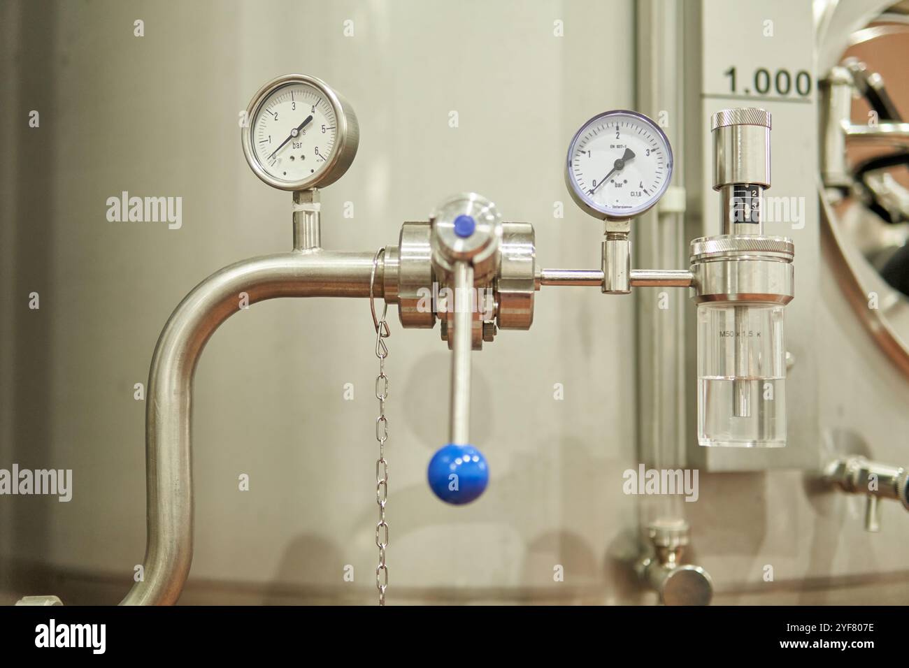 Close-up of an industrial stainless steel pressure gauge with valves and controls Stock Photo