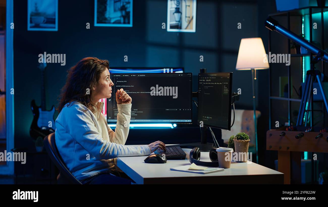 Cybersecurity expert using computer and augmented reality to look for company security vulnerabilities and injected malware. Programmer installing code on PC, looking at AR visualization, camera A Stock Photo