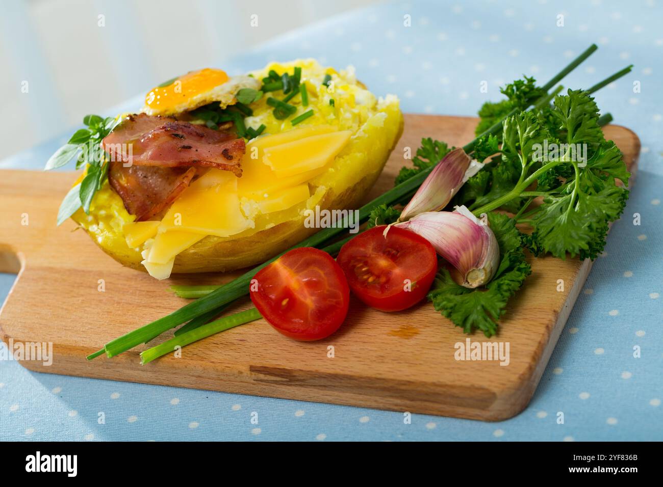 Tasty potato stuffed with eggs, bacon, cheese Stock Photo