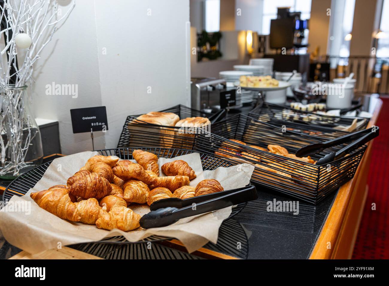 Selection of Golden Croissants and Toast in Black Wire Baskets on ...