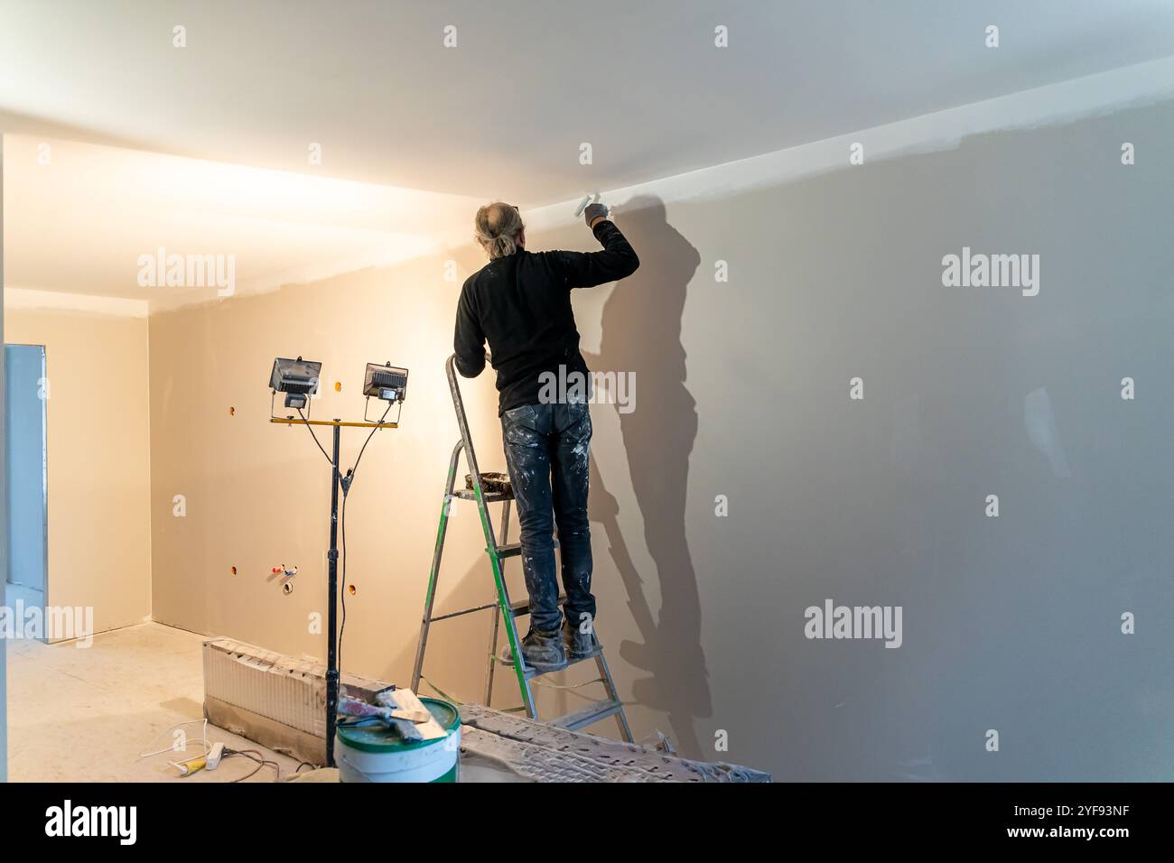 craftsman meticulously applying finishing touches to a wall with ...