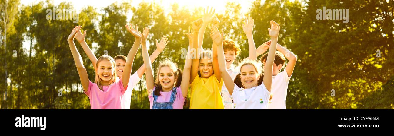 Group of happy smiling kids friends having fun and raising hands up in ...