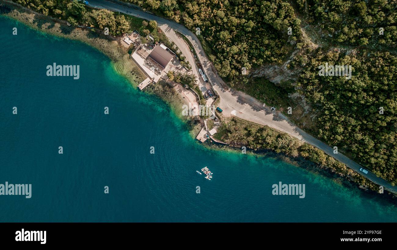 aerial view of colorful stand-up paddleboards lined up on a serene beachfront Stock Photo