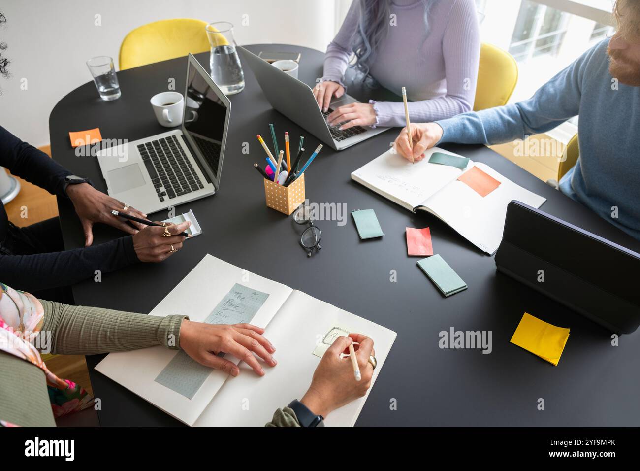 High angle view of male and female business professionals working in conference room Stock Photo