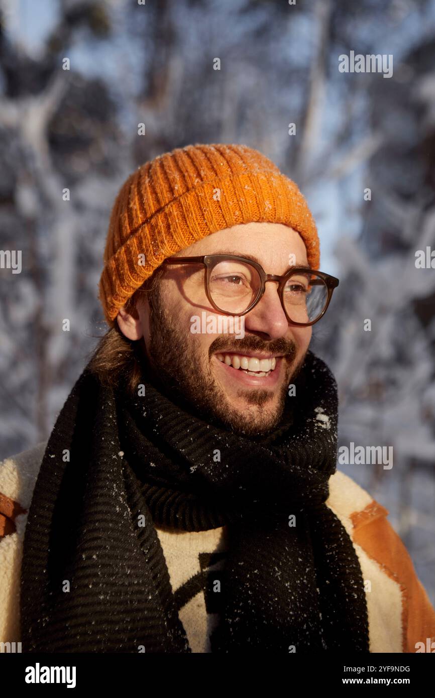 Happy man wearing eyeglasses and beanie during winter season Stock Photo