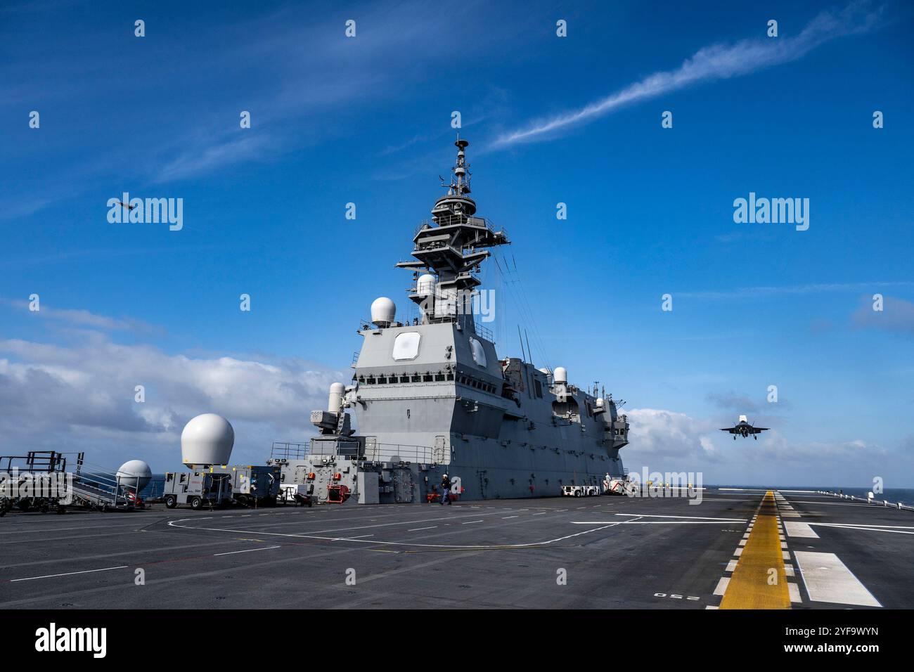 An F-35B Lightning II aircraft executes a vertical landing on Japan Maritime Self-Defense Izumo-class multi-functional destroyer JS Kaga (DDH 184) during developmental test Nov. 2, 2024, in the eastern Pacific Ocean. Royal Navy Lt. Cmdr. Nick Baker, F-35 test pilot, a member of the F-35 Patuxent River Integrated Test Force (Pax ITF) assigned to Air Test and Evaluation Squadron Two Three (VX-23), held over the deck as U.S. Marine Maj. Zach Laser, F-35 test pilot, Pax ITF, VX-23, flew overhead preparing to land on the MSDF’s largest ship. Pax ITF flight test members, U.S. Sailors and Marines, an Stock Photo