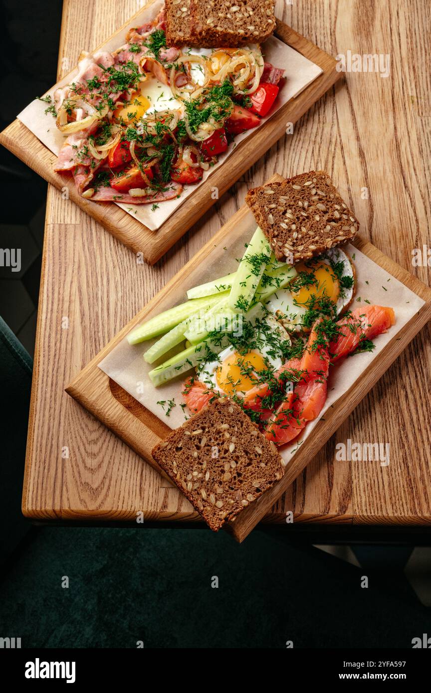 fried eggs with vegetables and bread on a plate Stock Photo