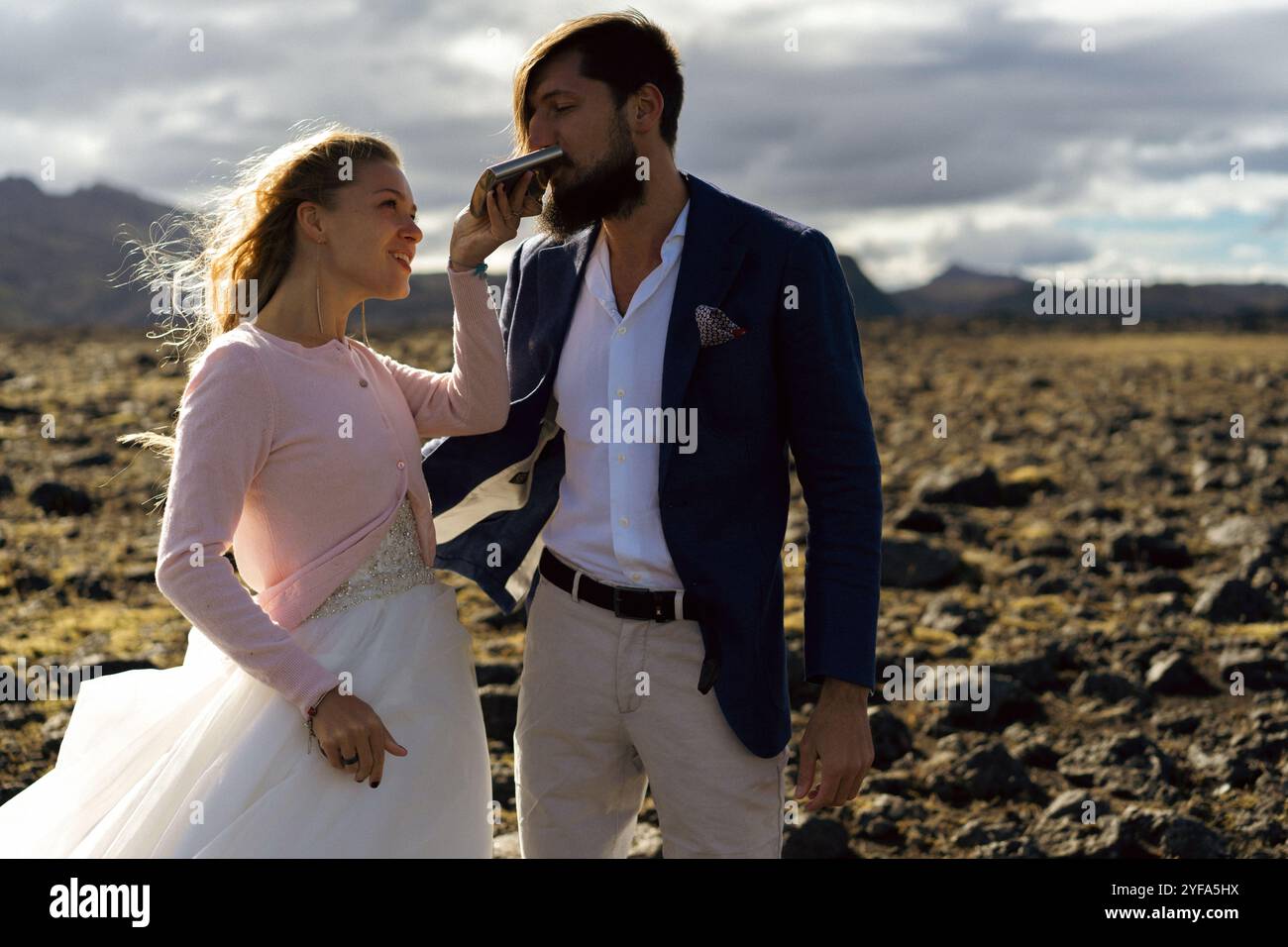 Couple in wedding suits in Iceland against the mountains Stock Photo