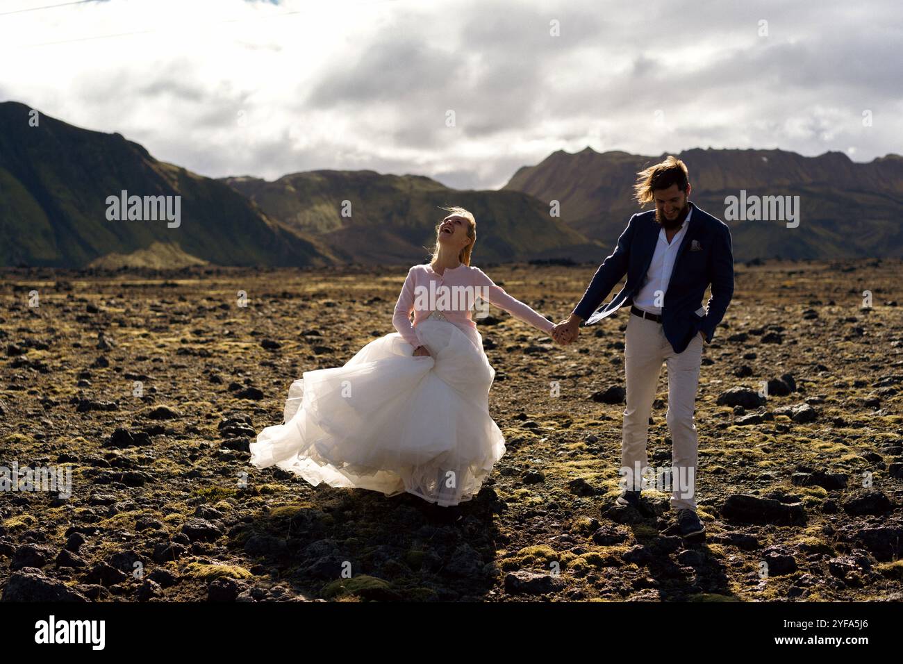 Couple in wedding suits in Iceland against the mountains Stock Photo