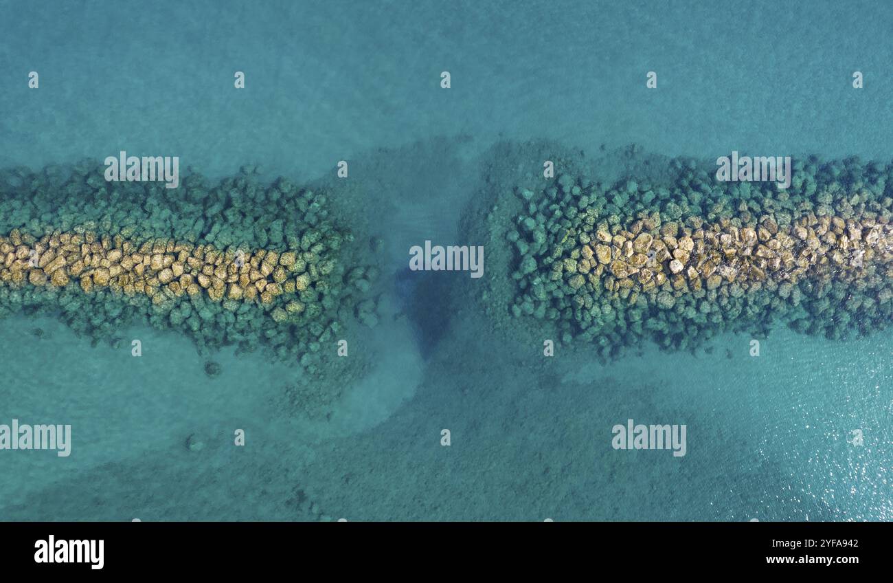 Aerial view from flying drone of crystal blue water and sea wall Stock ...