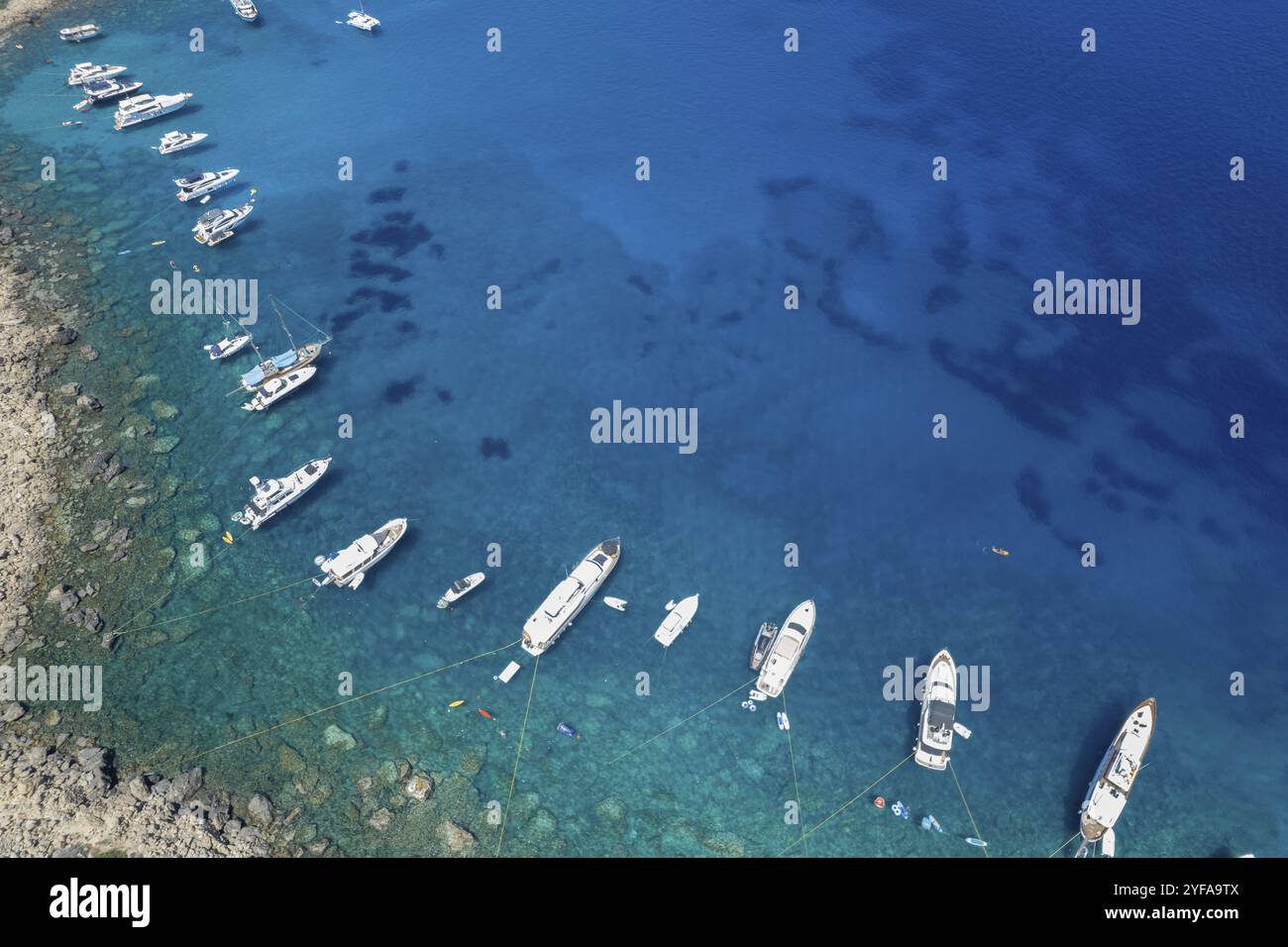 Drone aerial seascape with luxury yachts moored on the coast and unrecognised people swimming and relaxing. Summer vacations in the sea. Ayia Napa Cyp Stock Photo