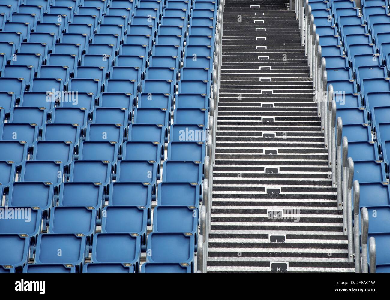 Blue plastic empty stadium or stage chairs in a row Stock Photo