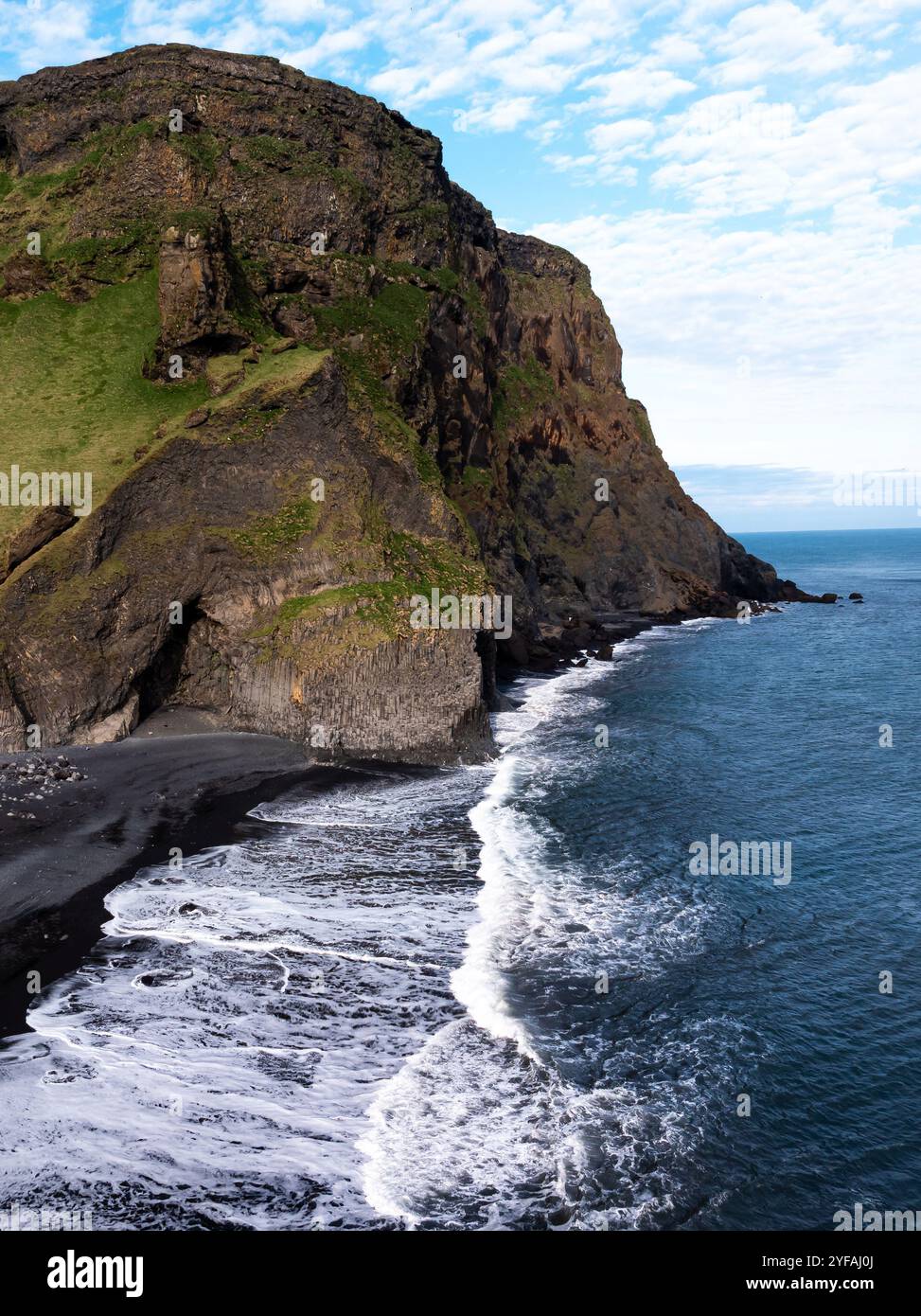 Aerial view of Reynisfjara black sand beach and sea stacks in Iceland ...