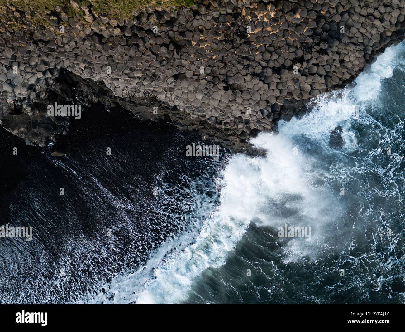 Aerial view of basalt columns and crashing waves at Reynisfjara black ...