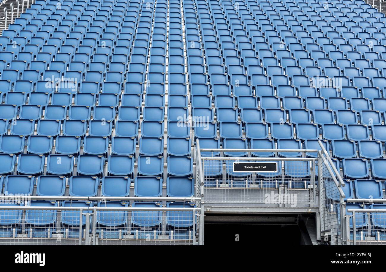 Blue plastic empty stadium or stage chairs in a row Stock Photo