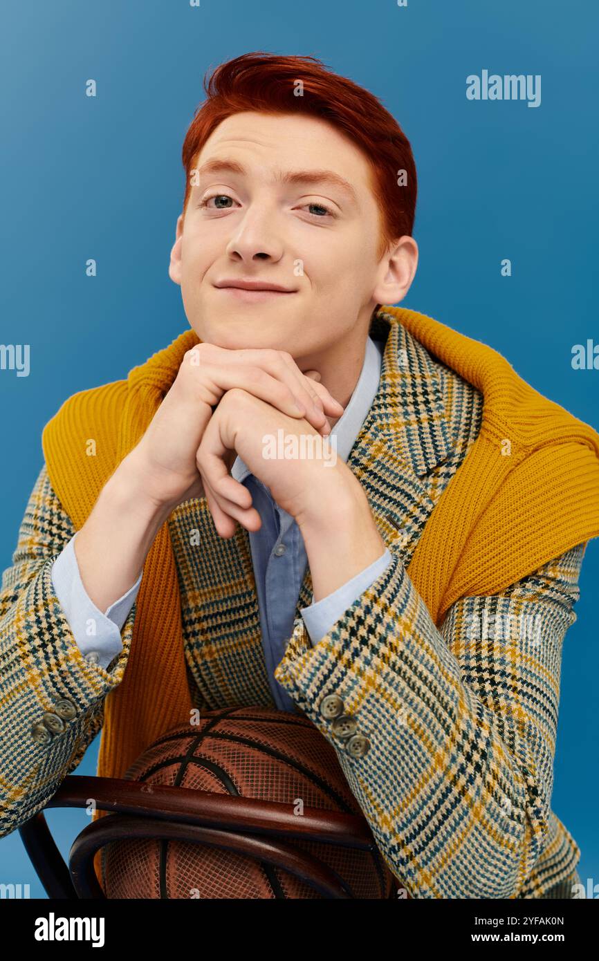 A stylish man with red hair poses confidently in a chic winter outfit ...