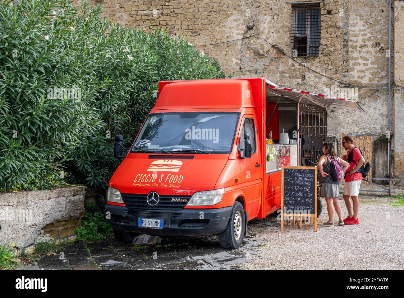 Tourists ordering at food truck, Corricella, Procida, Campania, Italy Stock Photo