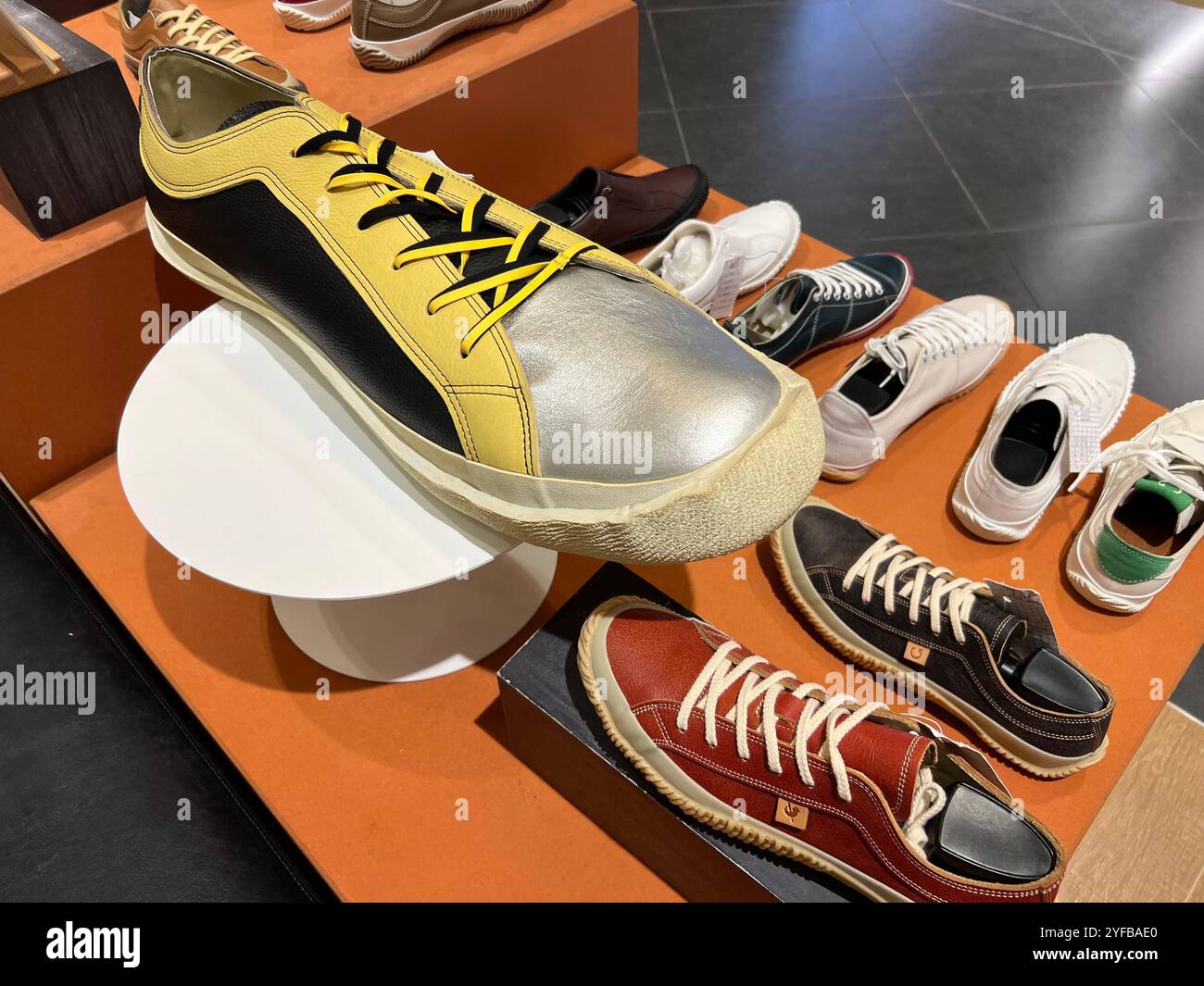 A huge Spingle handmade mens sneakers on display departmental store. The scale of it can be compare with their normal sizes products. Made in Japan. - Smartphone Captured Stock Image
