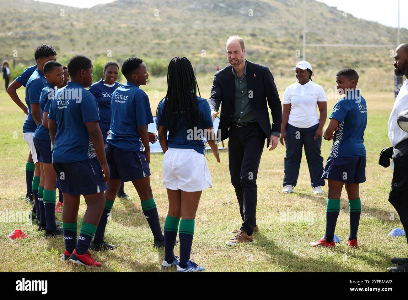 The Prince of Wales takes part in a rugby coaching session, during a visit to Ocean View Secondary School, in Cape Town, to meet young people from Ocean View, Masiphumelele and Langa Townships who regularly participate in the Atlas Foundation's rugby training and digital skills programme, on day one of his visit to South Africa, ahead of the fourth annual Earthshot Prize Awards ceremony on November 6. Picture date: Monday November 4, 2024. Stock Photo