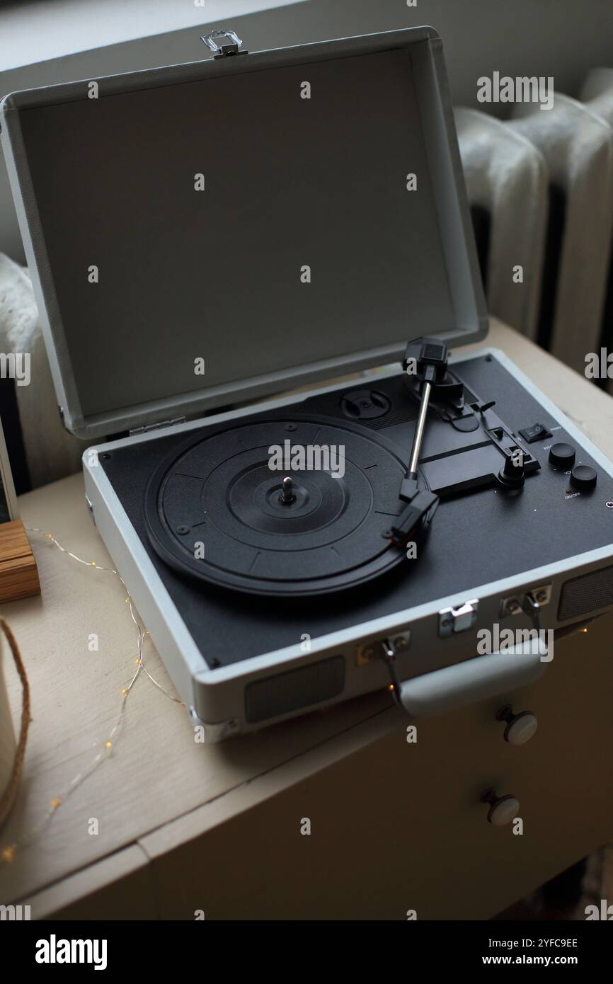 a vintage vinyl record player elegantly positioned on a rustic wooden ...