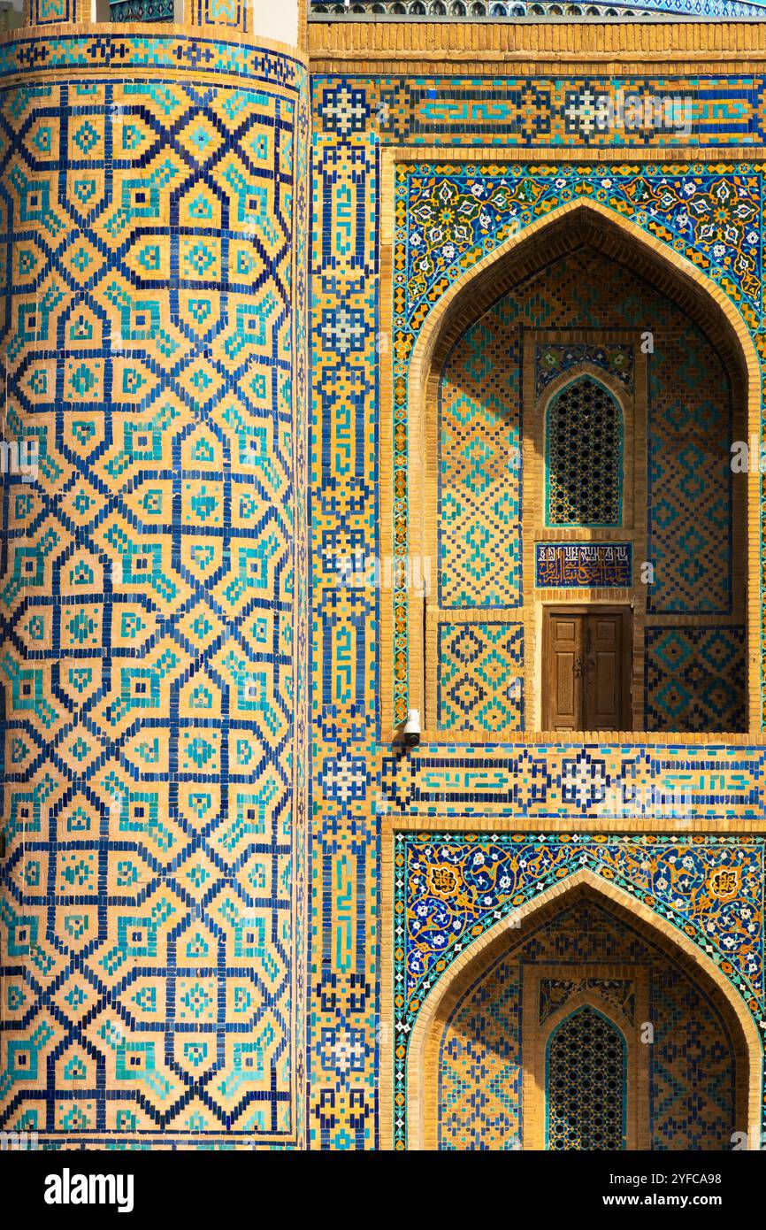 Exterior view of the Sher-Dor Madrasah the walls are decorated with bright ornaments of glazed brick and towers are covered with majolica of various d Stock Photo