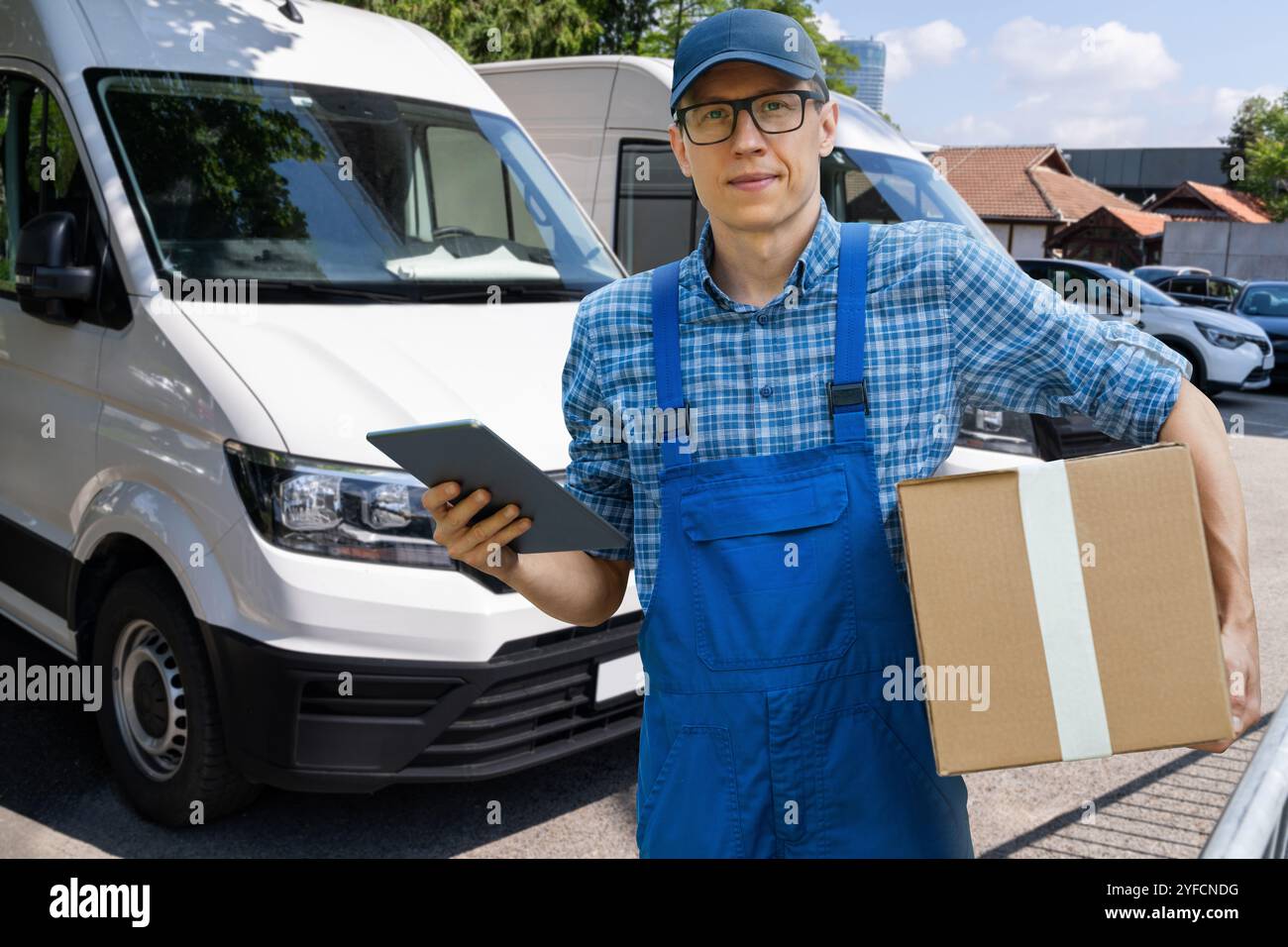 Delivery man in uniform with digital tablet. Stock Photo