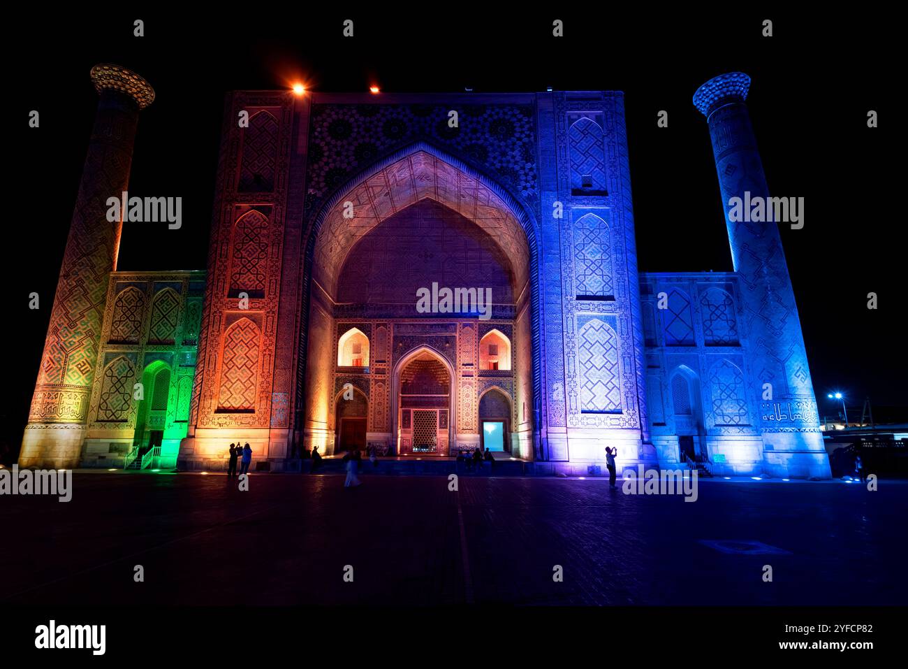 The Ulugbek Madrasah during the laser light show at night. The Ulugbek Madrasah located by Registan Square in the historic center of Samarkand, Uzbeki Stock Photo