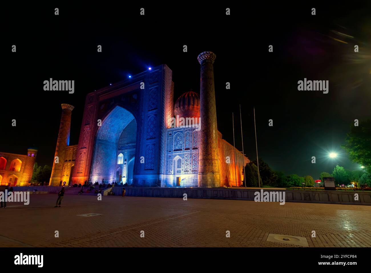 Night view of  the Sher-Dor Madrasah located by Registan square. It is part of Ensemble of Registan in historic center at the heart of Samarkand, Uzbe Stock Photo