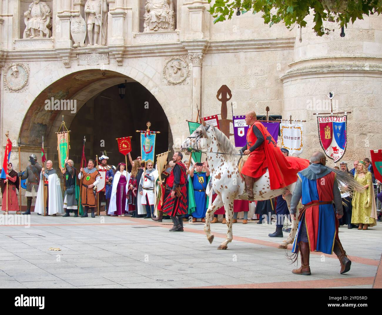 People on horseback in the procession passing the Arco de Santa Maria ...