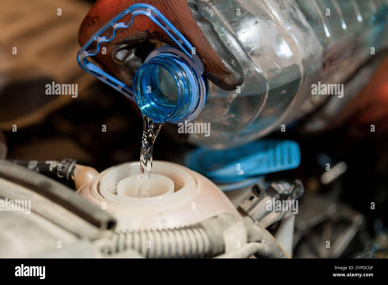 Filling a Car's Radiator with Water from a Plastic Bottle Stock Photo ...