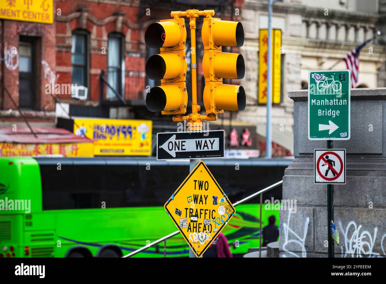 A busy street scene in New York City featuring a yellow traffic light ...