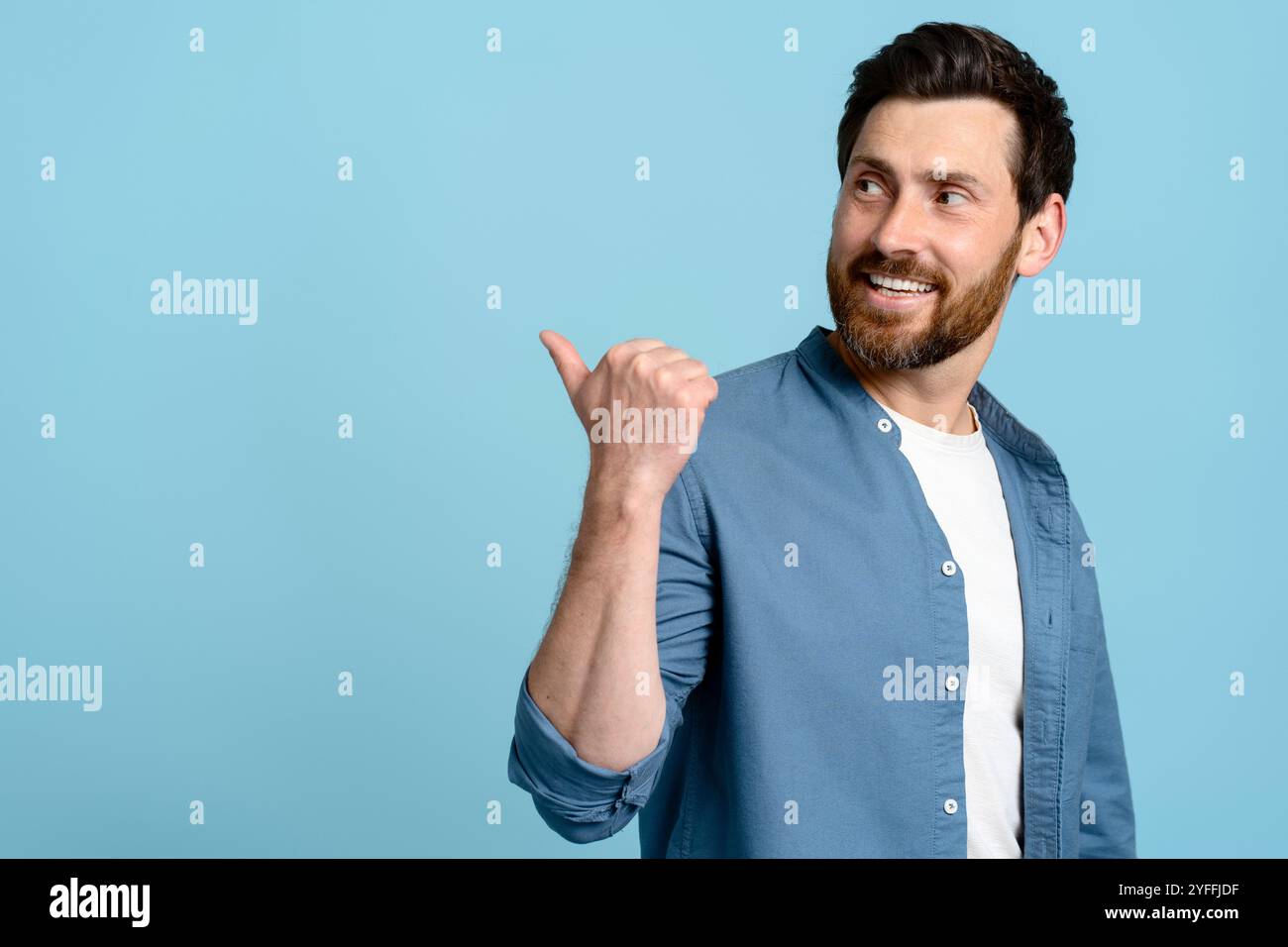 Smiling corporate guy looking at something Stock Photo - Alamy