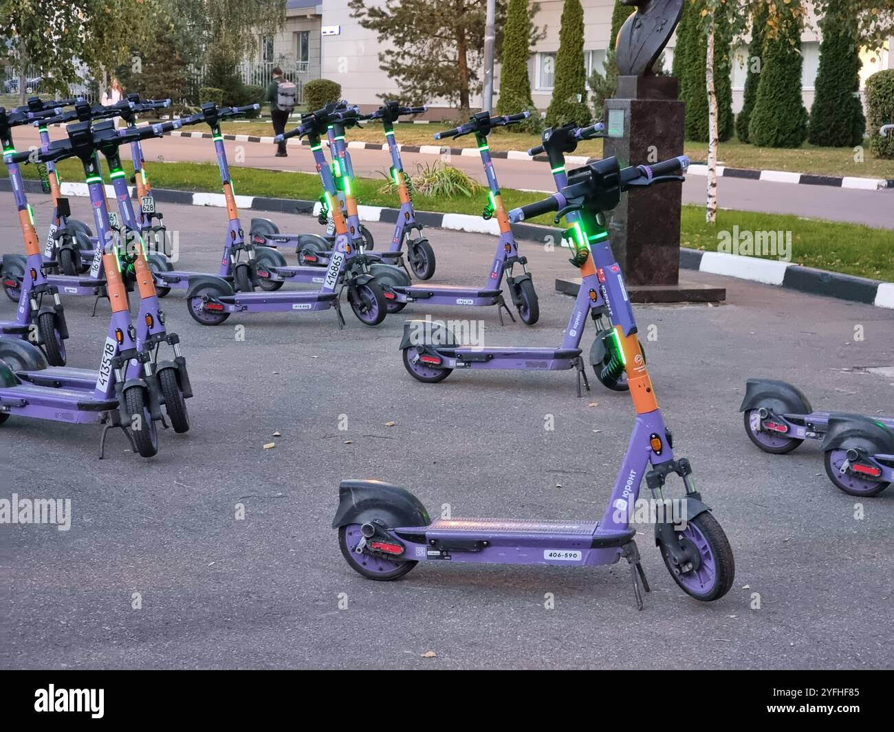 Large number of electric rental scooters left behind on a square; lights are flashing; blue scooters - Smartphone Captured Stock Image