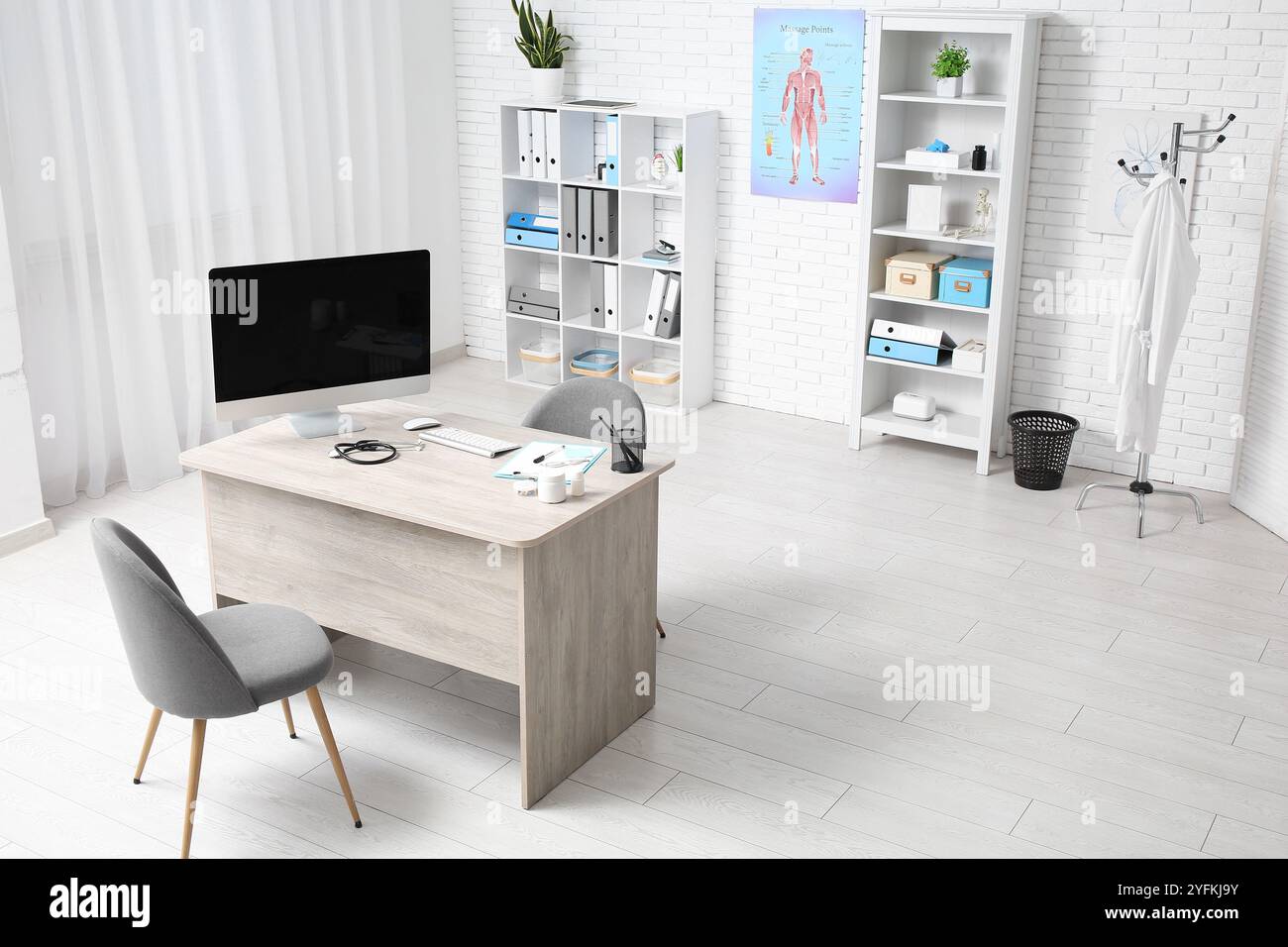 Interior of medical office with doctor's workplace and shelf units ...