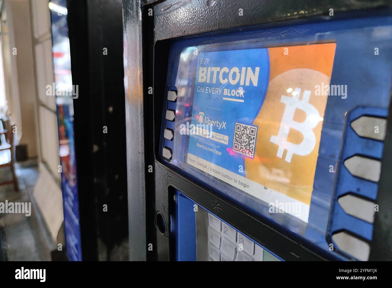 New York, USA. A Bitcoin ATM is advertised in the window of a New York city  deli. Photo by Enrique Shore Stock Photo - Alamy